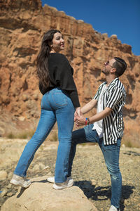 Side view of a couple standing outdoors