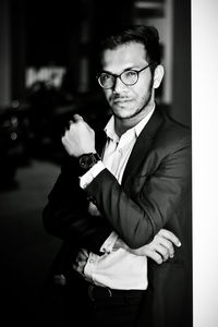 Portrait of young man sitting on wall