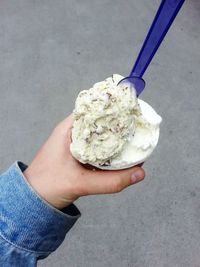 Close-up of hand holding ice cream