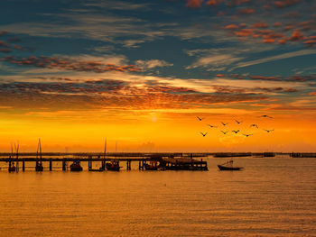 Scenic view of sea against orange sky