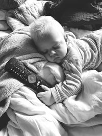 High angle view of cute baby lying on bed