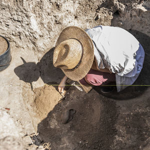 Archaeologist uncovering artifacts remains