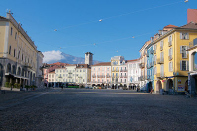 Buildings in city against blue sky