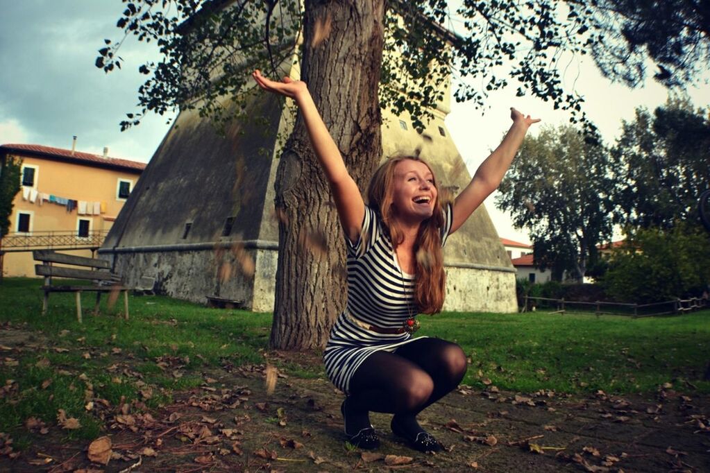 person, young adult, young women, portrait, looking at camera, tree, full length, casual clothing, lifestyles, front view, grass, standing, smiling, leisure activity, park - man made space, happiness, long hair