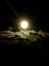 Low angle view of illuminated moon at night