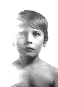Close-up portrait of shirtless boy against white background