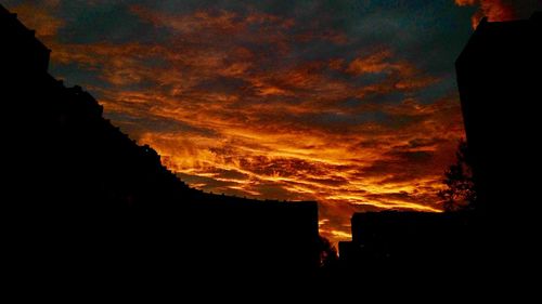 Silhouette of mountain against cloudy sky