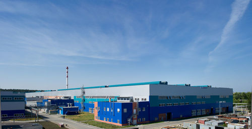 Metallurgical plant against blue sky on sunny day