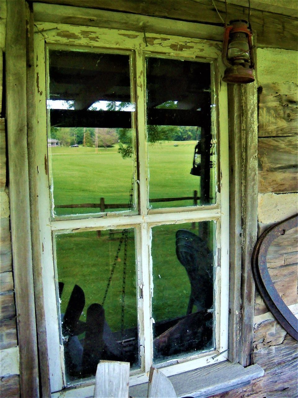 OLD ABANDONED HOUSE SEEN THROUGH WINDOW