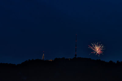 Low angle view of firework display at night