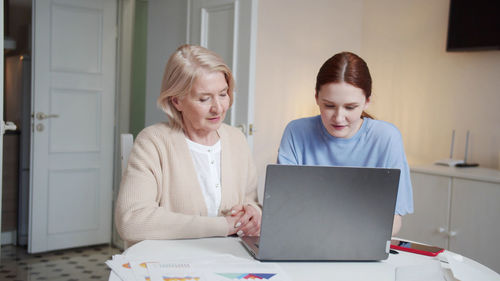 Young woman using laptop at home