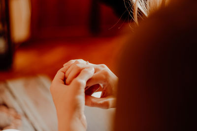 Close-up of cropped hands wearing ring