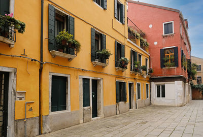 View of residential building with vintage painted wooden door and windows with vintage blinds.