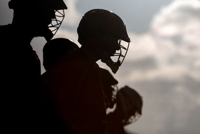 Portrait of silhouette players standing against sky