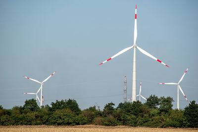 Windmill on field against sky
