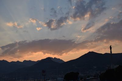 Scenic view of mountains against cloudy sky