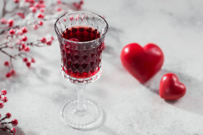 Red cocktail, vodka or liqueur and heart shape decorations