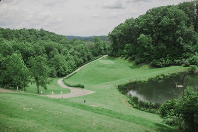 High angle view of golf course against sky