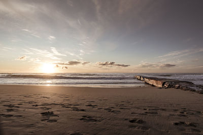 Scenic view of beach against sky during sunset