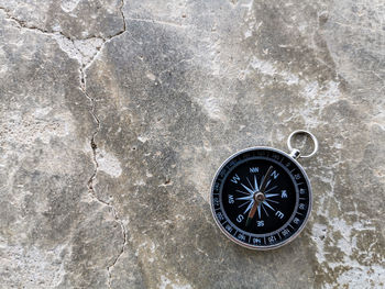 Close-up of navigational compass on rock