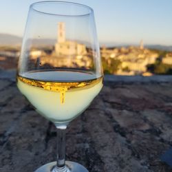 Close-up of alcohol in glass with reflection against clear sky