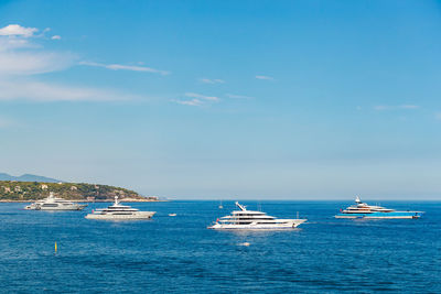 Boats in sea against sky