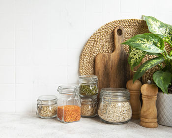 Kitchen utensils, tools and dishware on on the background white tile wall. 