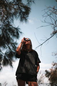 Rear view of woman standing against sky