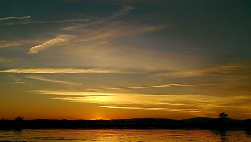 Scenic view of lake at sunset