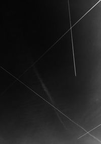 Low angle view of vapor trails in blue sky