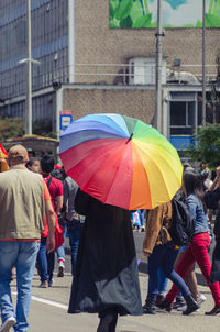 Rear view of people walking in rain