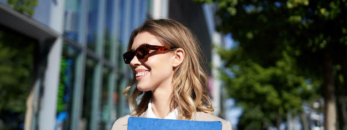 Young woman wearing sunglasses standing outdoors