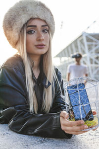 Portrait of young woman wearing hat