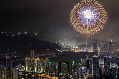 Firework display over illuminated cityscape and gwangan bridge