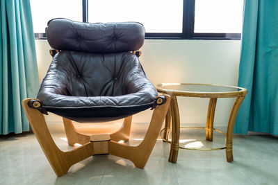 Rear view of woman sitting on chair at home