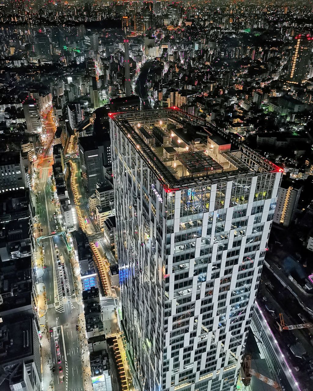 AERIAL VIEW OF ILLUMINATED CITY BUILDINGS