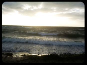 Scenic view of sea against cloudy sky