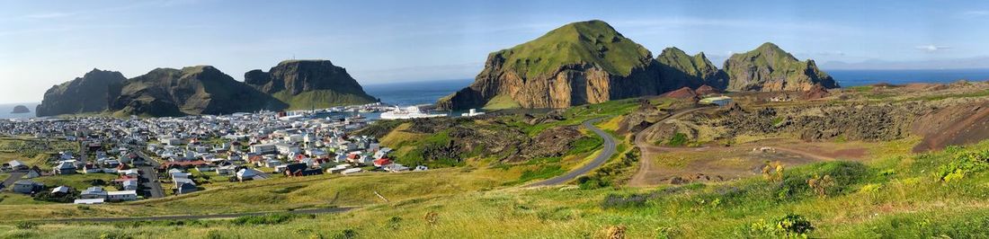 Panoramic view of people on mountain against sky