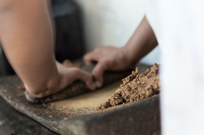 Midsection of chef crushing cocoa on mortar