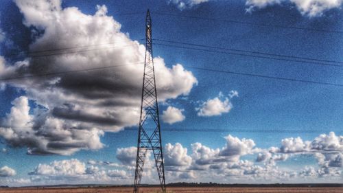 Low angle view of electricity pylon against sky