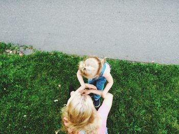 Directly above shot of mother with daughter on grass