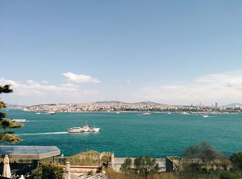 High angle view of boats in sea against blue sky