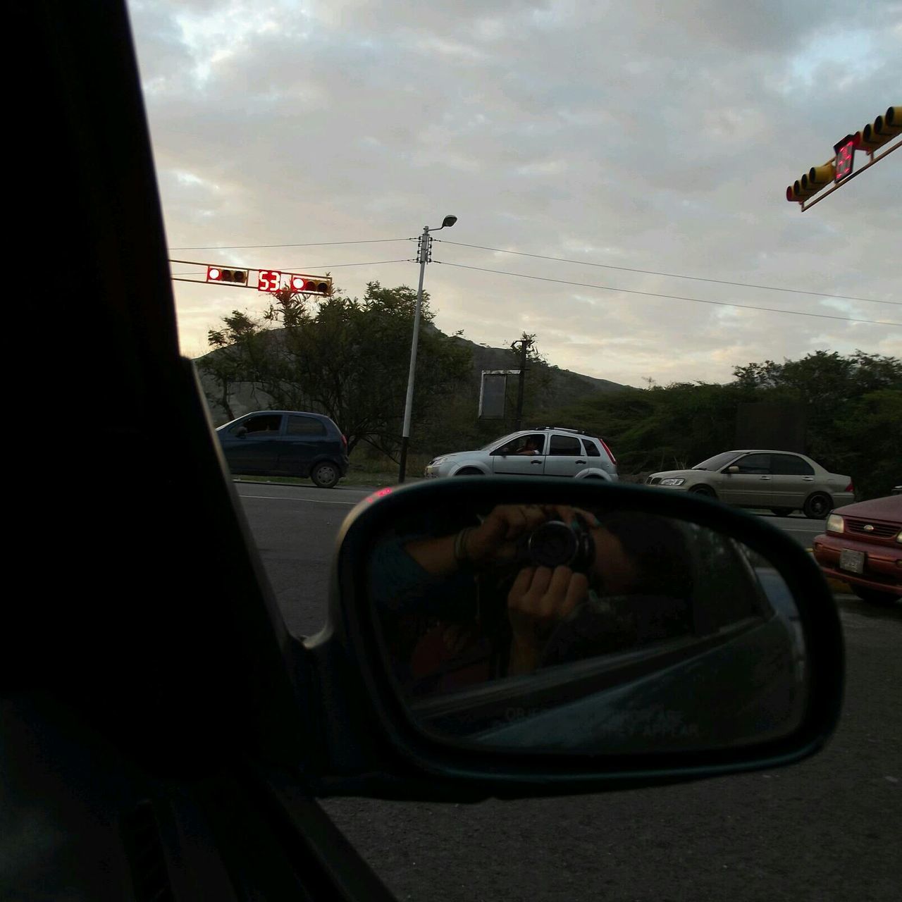 transportation, car, land vehicle, mode of transport, sky, street, cloud - sky, road, traffic, travel, on the move, sunset, cloud, vehicle, vehicle interior, stationary, city, cloudy, windshield, car interior