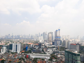 High angle view of modern buildings in city against sky