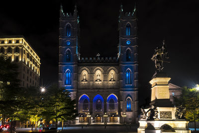 Illuminated cathedral in city at night