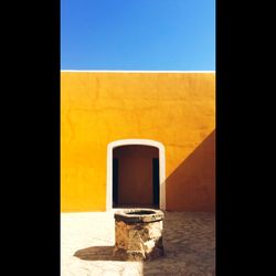 Close-up of yellow window on wall