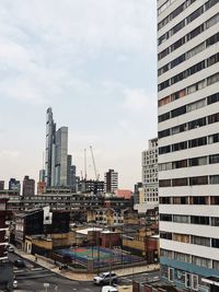 View of skyscrapers against cloudy sky