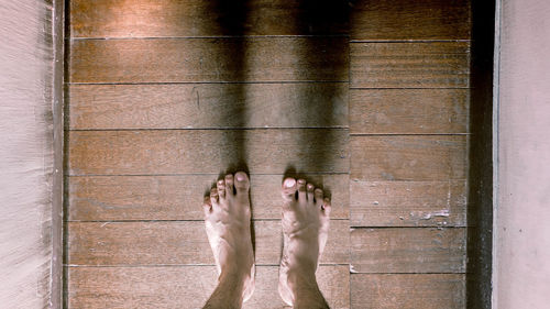 Low section of woman standing on tiled floor