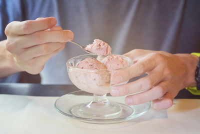 Midsection of ice cream cone on table