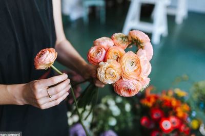 Close-up of hand holding rose bouquet
